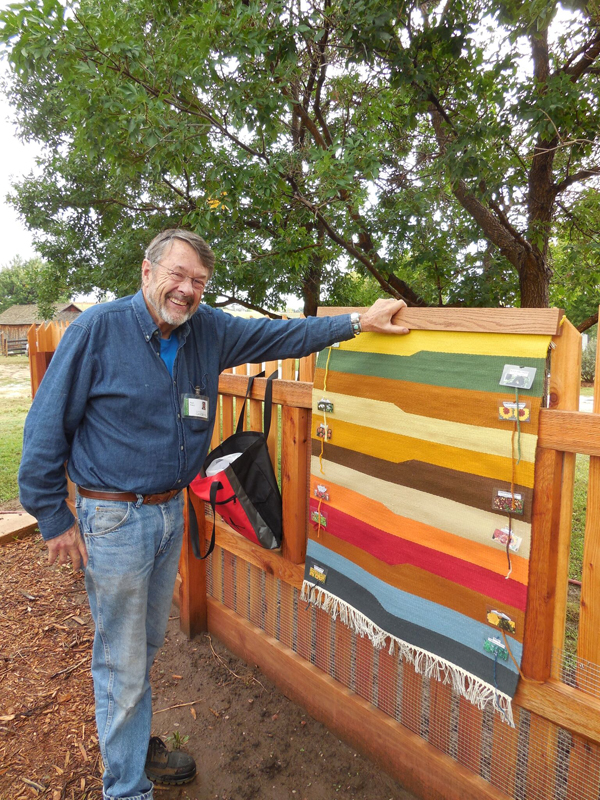 Paul Tracy showing his tapestry woven with yarns dyed from 2014 dye garden plants