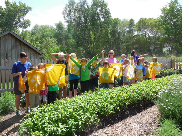 Campers showing off their marigold-dyed bandannas