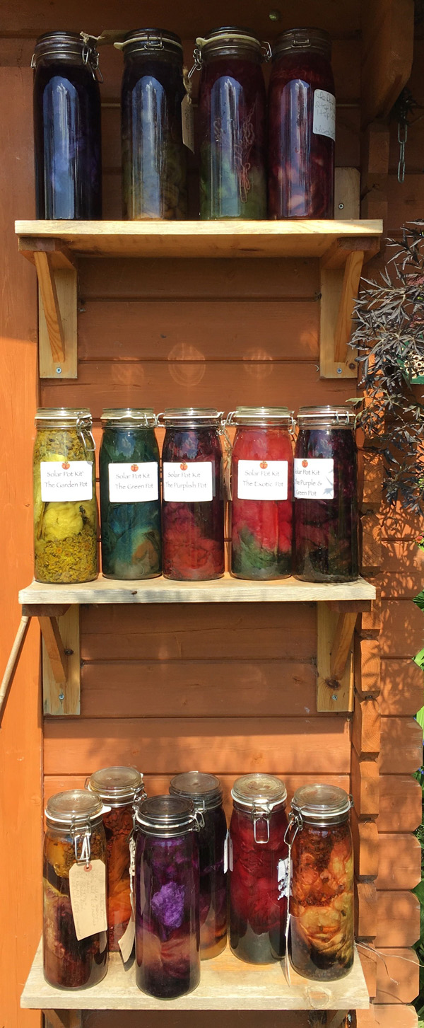 Solar pots containing dyes, mordant and fibres warming in the sun