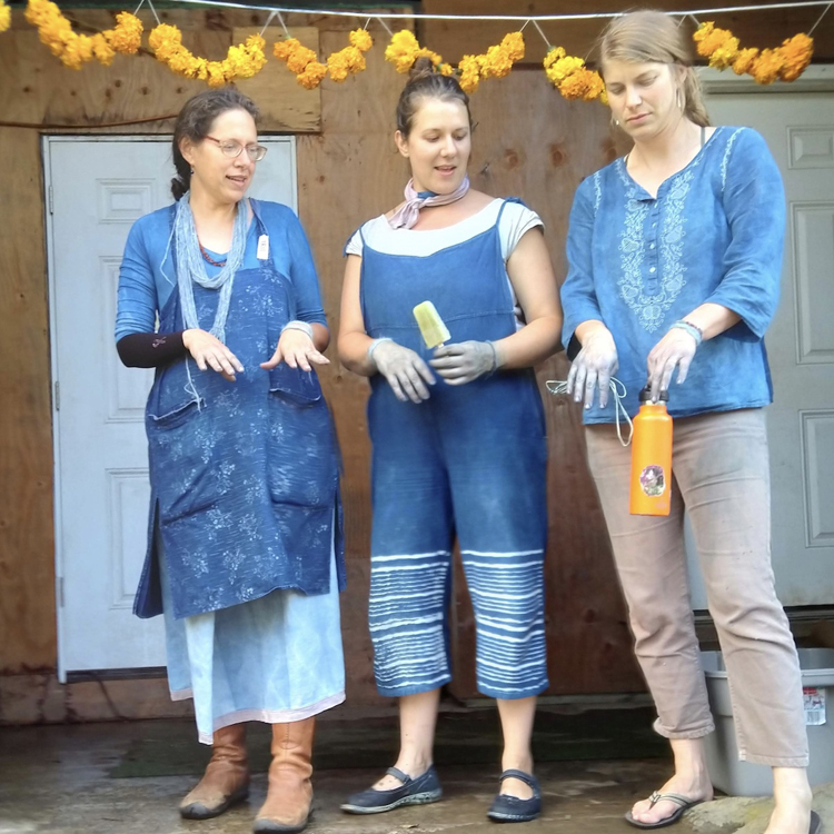 Iris Sullivan Daire, Brittany Boles, and Kyla Sjogren, compare their blue hands after IndigoFest 2018